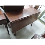 A 19th century mahogany dining table having square drop leaf top and gate legs with pad feet