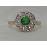 A lady's dress ring having a green paste and cubic zirconia cluster in a pave mount on a yellow
