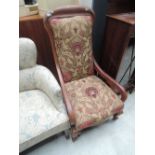 A Victorian mahogany frame armchair having later 20th century floral upholstery and knurl legs