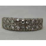 A ladies dress ring having a double row of diamonds in a pave mount, approx 1ct total on an 18ct