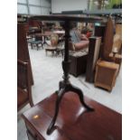 An early 20th century mahogany wine table having circular top on column and triple splay legs