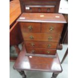 An early 20th century oak jewellery chest of small drawers