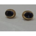 A pair of tanzanite style stud earrings in yellow metal surrounds, no marks, possibly 9ct gold