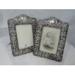 A pair of Edwardian silver and velvet photograph frames of arched rectangular form having floral