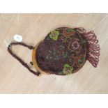 Antique beaded handbag having clasp fastening, fringing to bottom and floral pattern.
