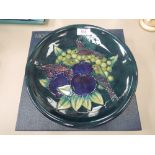 A modern Moorcroft plate in Finch & Fruit Berry pattern on blue/green ground, impressed and