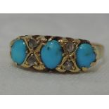 A lady's dress ring having three oval turquoise interspersed by diamond chips in a gallery mount