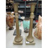 A pair of cast brass candlesticks of flouncey form