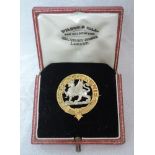 A cased yellow metal brooch stamped 9ct having central dragon with FEAR GOD IN LIFE motto to