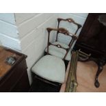 A pair of late Victorian mahogany aesthetic style occasional chairs having later upholstered seats