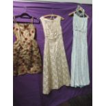 A lot of three vintage 1950s dresses, two full length and one shorter with peplum detailing. Small