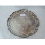 A silver card tray of shaped circular form having a raised pie crust rim, inscription to centre