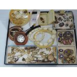 A selection of costume jewellery including mother of pearl charms, yellow metal charms, 9ct gold tie