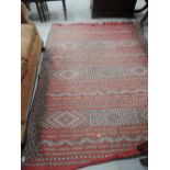 An early/mid 20th century Eastern carpet square having red, black and cream ground