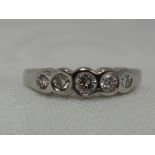 A lady's dress ring having five graduated diamonds in a collared mount on a 9ct white gold loop,