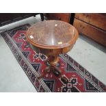 A mid Victorian walnut sewing table having circular lift fitted top on tapered column and triple