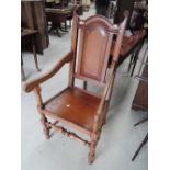 An early 20th century mid oak carver armchair in the 18th century style, having panel and baluster