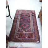 A traditional rug having red and blue ground