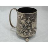An Edwardian silver christening mug having moulded art nouveau style decoration, inscription to
