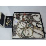 A selection of white metal and other costume jewellery including necklaces, bangles, earrings, and