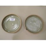 A pair of St Ives pottery dishes by Bernard Leach having green glaze and with seal mark
