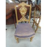 A late Victorian gilt wood occasional chair having ornate crest back with star upholstery on