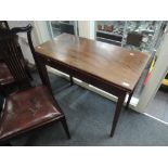 A 19th century mahogany fold over tea table on tapered gate legs