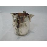 An Edwardian double spout cream jug of plain form having loop handles, London 1903, makers marks