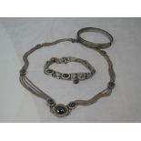 A white metal four strand necklace and bracelet stamped 925/900 having hematite set panels, and an