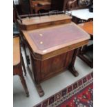 A Victorian walnut ecclesiastical desk of Davenport style having raised gallery back with slope