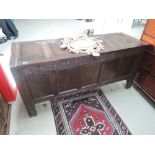 A late 17th century oak kist/coffer having carved lattice decoration and dated 1699, with panel