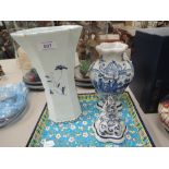 A Dutch Delft design blue and white vase having pictorial decoration and a similar lidded jar and