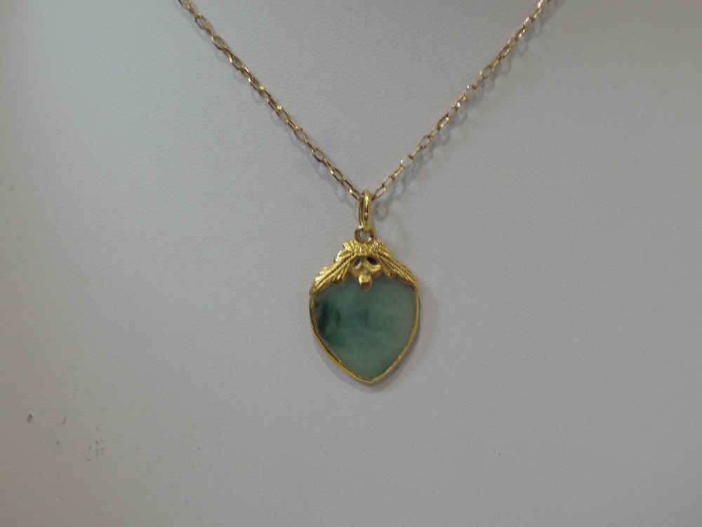 A jadeite style heart shaped pendant in a yellow metal mount on a 9ct gold chain (AF)