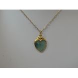 A jadeite style heart shaped pendant in a yellow metal mount on a 9ct gold chain (AF)