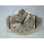 A gents 9ct gold automatic wrist watch by Garrard having baton dial with sweeping second hand and