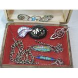 A small travel jewellery case containing a selection of white metal and HM silver jewellery