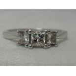 A lady's dress ring having a trilogy of graduated princess cut diamonds, total approx 0.75ct in a