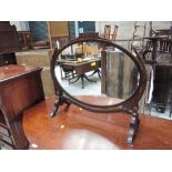 A late 19th century mahogany toilet/swing mirror having oval panel on shaped frame