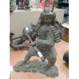 A bronzed figure modelled as a Samurai warrier