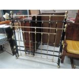 A Victorian style black iron and brass double bedstead