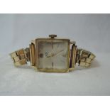A lady's 18ct gold wrist watch by Xo having a baton and Arabic numeral dial to square face on a