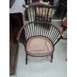 An early 20th century stained frame comb back chair having later cane seat