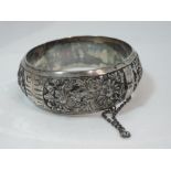 A white metal hinged bangle stamped silver French Indonesia having extensive moulded and engraved