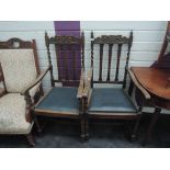 A pair of early 20th century oak Jacobean style carver armchairs having slat and twist and crest