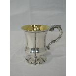 A William IV silver pedestal mug having fluted body, moulded handle, gilt interior and pedestal