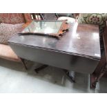A 19th century mahogany centre/dining table having drop flap top on turned column and quadruple