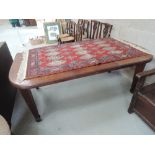 An Edwardian mahogany wind out dining table on tapered reeded legs, with leaf