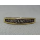 A lady's half eternity ring having eleven diamond chips, approx 0.15ct in a channel setting on a