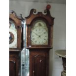 An early 19th century oak longcase clock having swan neck and pillar hood, containing painted dial