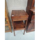 An early 19th century mahogany nightstand having lift top with inset space over drawer tier and